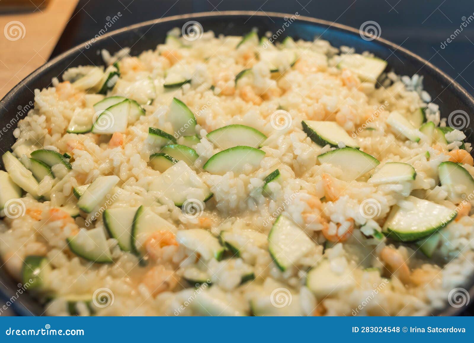 Creamy Risotto with Shrimp and Zucchini in a Frying Pan. Stock Photo