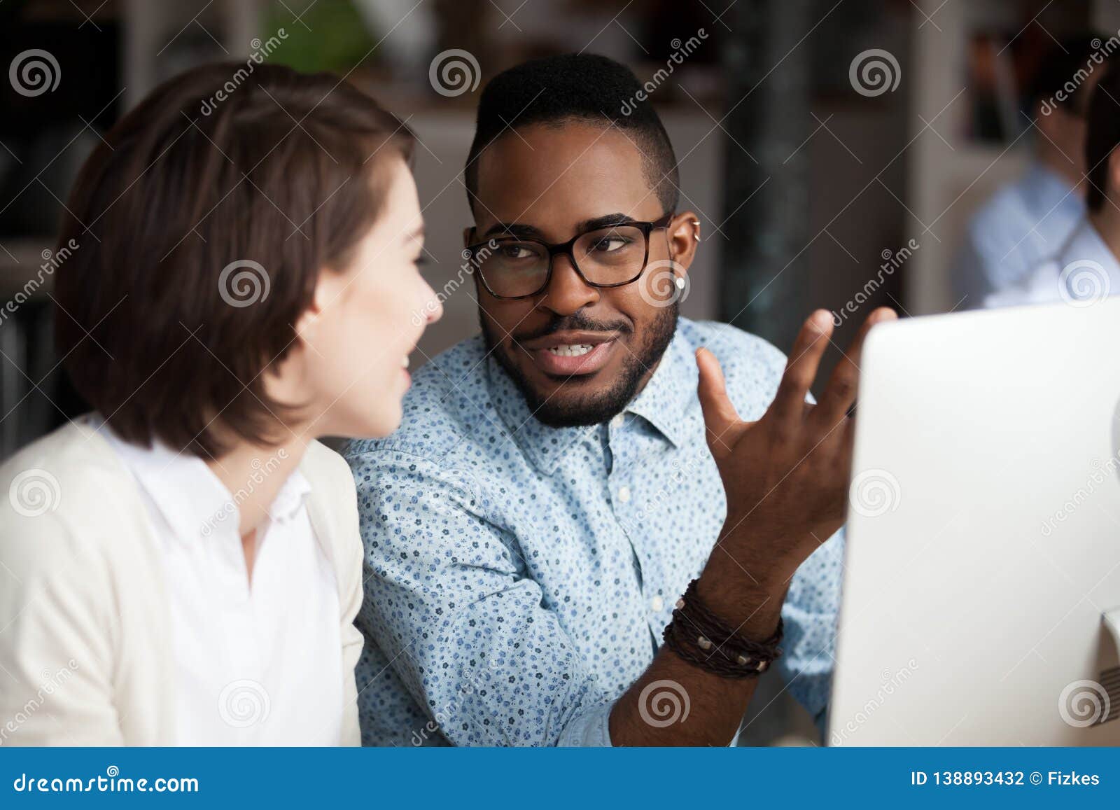 creative african american and caucasian workers discussing work chatting