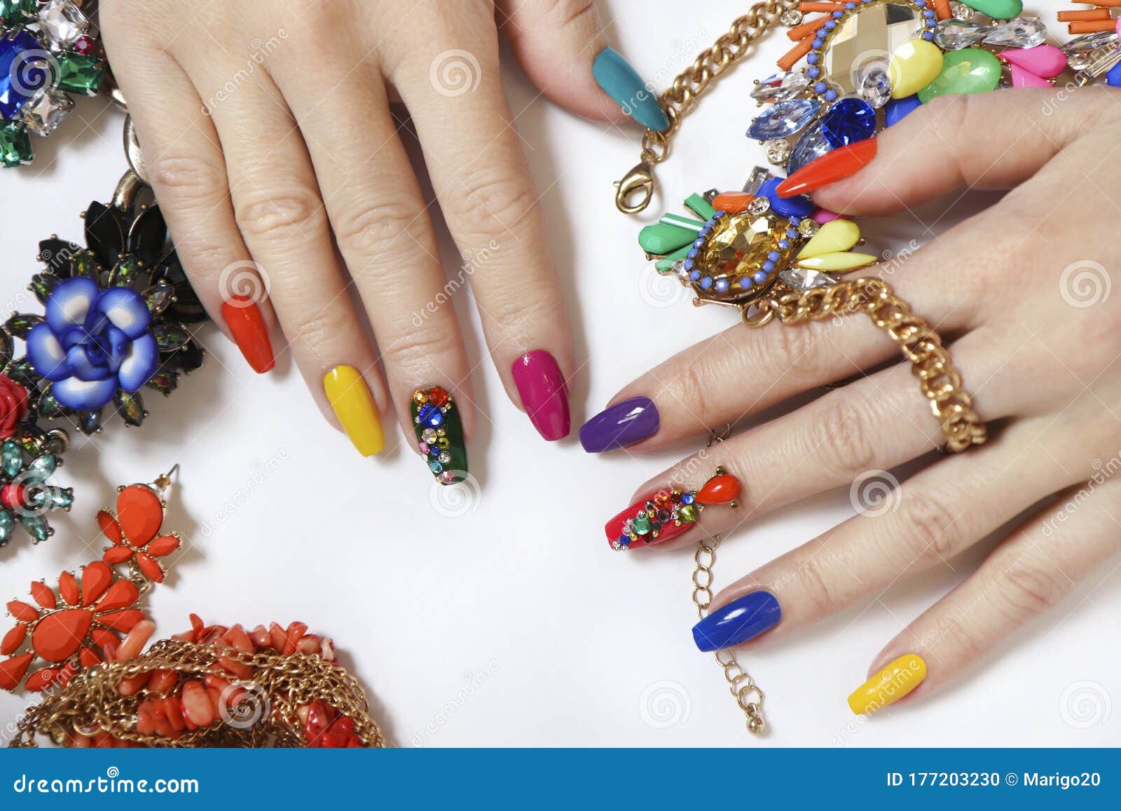 creative bright saturated manicure on long nails with rhinestones.