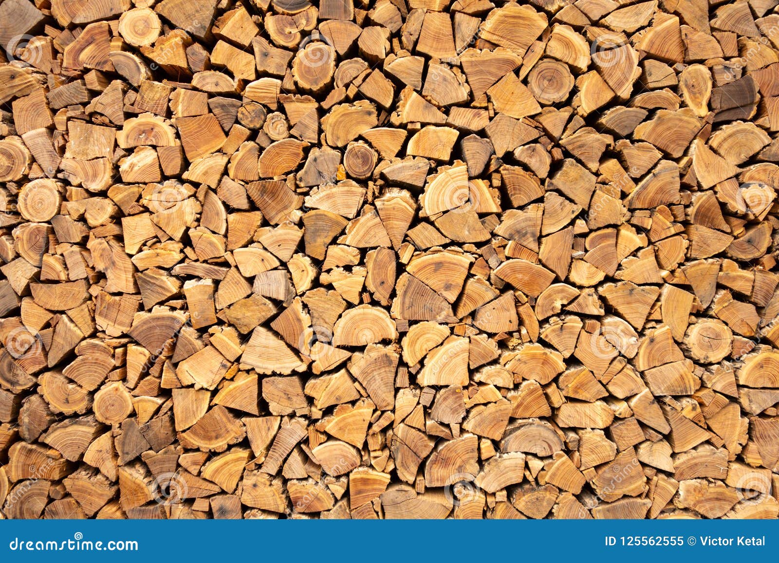 creative brown background of neatly stacked firewood. brown texture of natural wood.