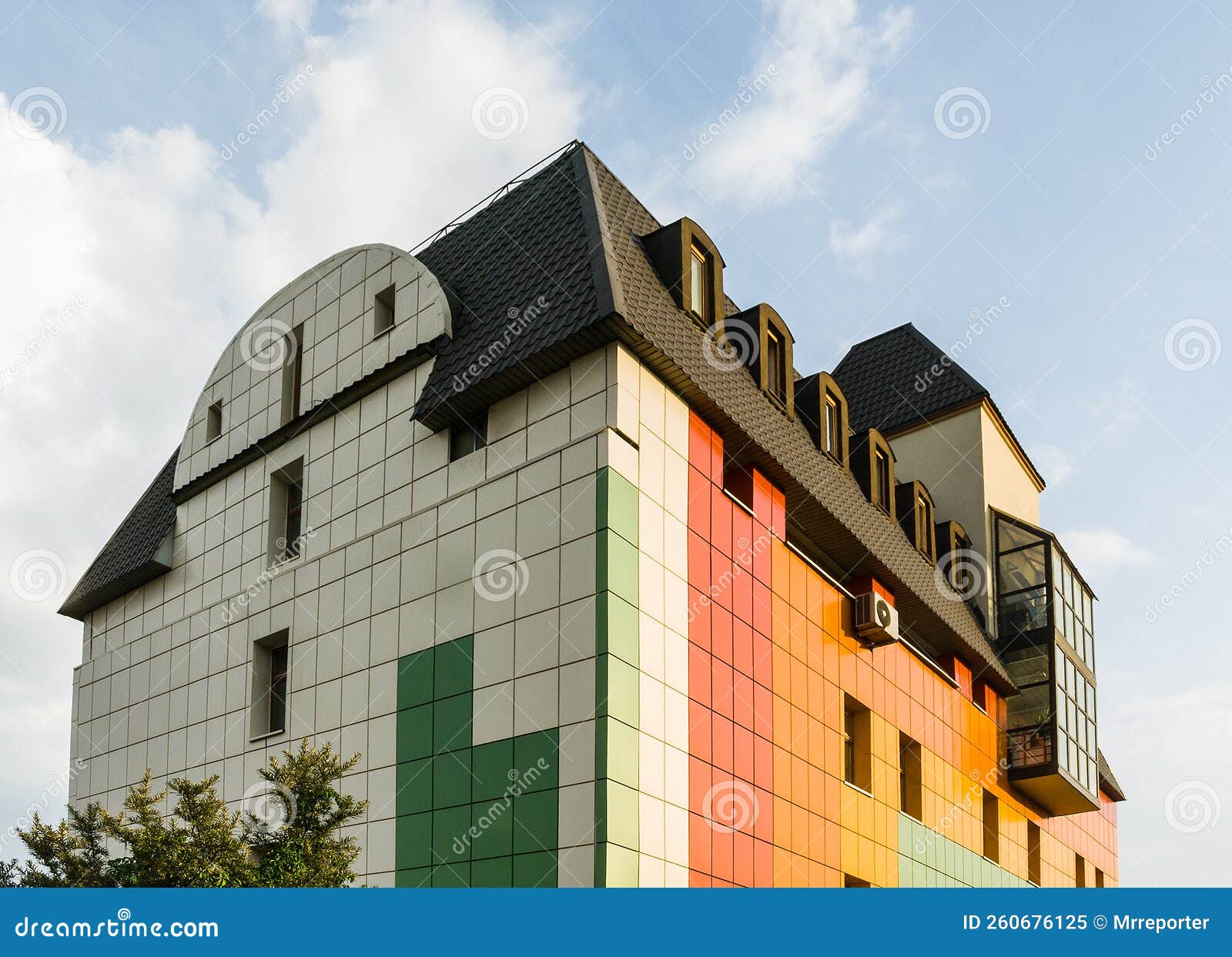 creative colorful exterior of the commercial lowrise townhouse building architecture with a ventilate facade and loft mansard roof