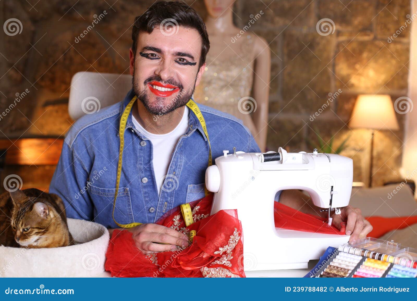 Creative Drag Queen Getting a Dress Ready with Sewing Machine Stock