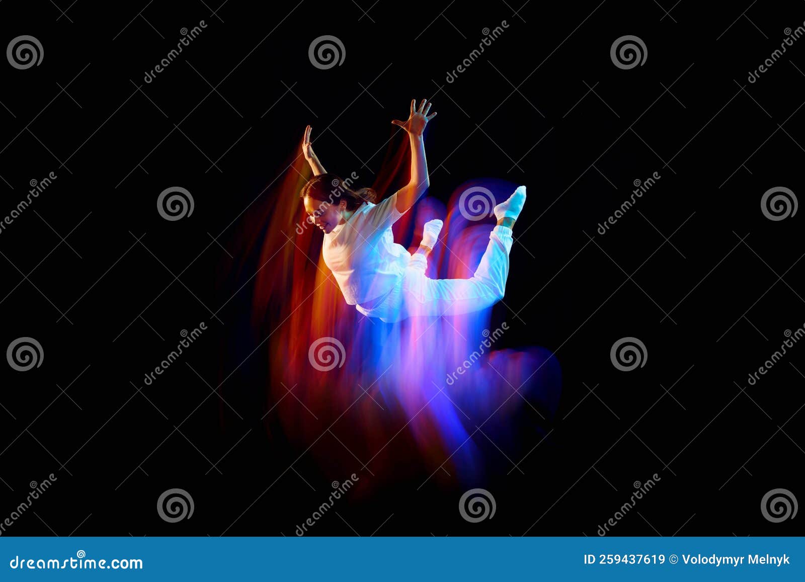 creative dynamic portrait of athlete, dancer in white sports clothes jumping, flying over dark background in mixed neon
