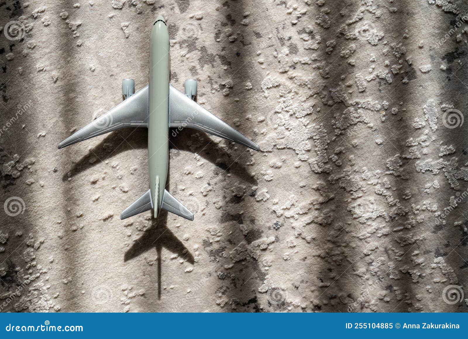 creative effect with sun light beam, airplane aircraft toy on grey background with lines