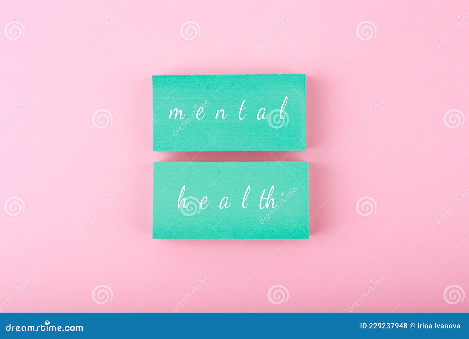 Mental Health Text Written on Blue Blocks on Pastel Pink Background
