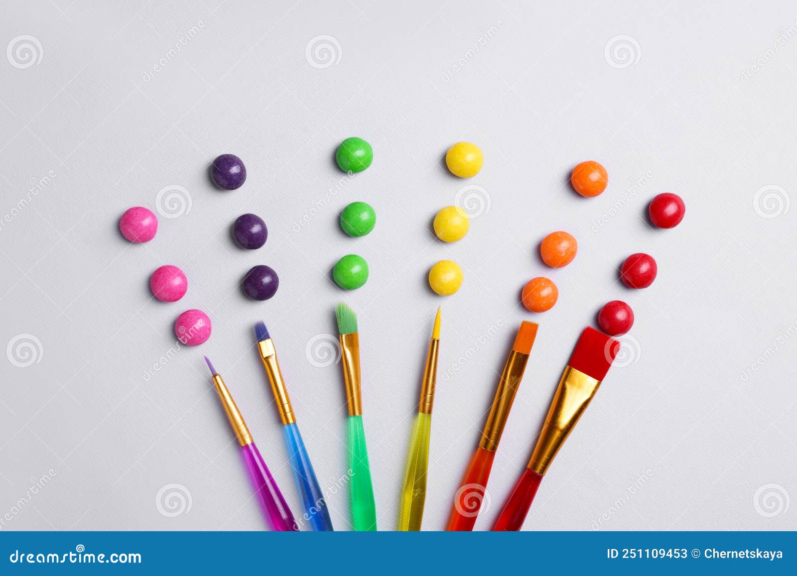 Creative Flat Lay Composition with Paint Brushes and Colorful Candies