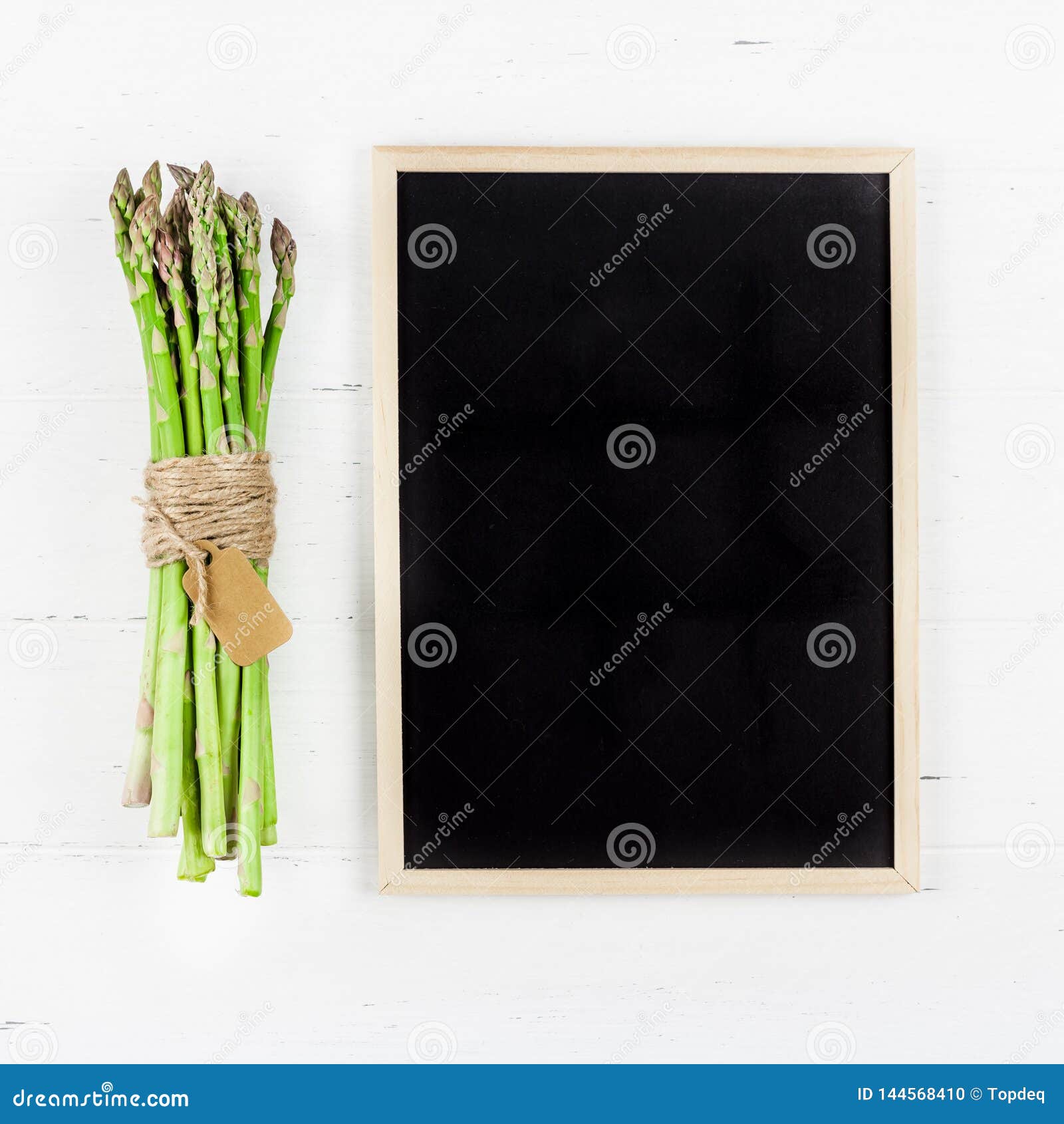fresh green asparagus with black chalkboard frame