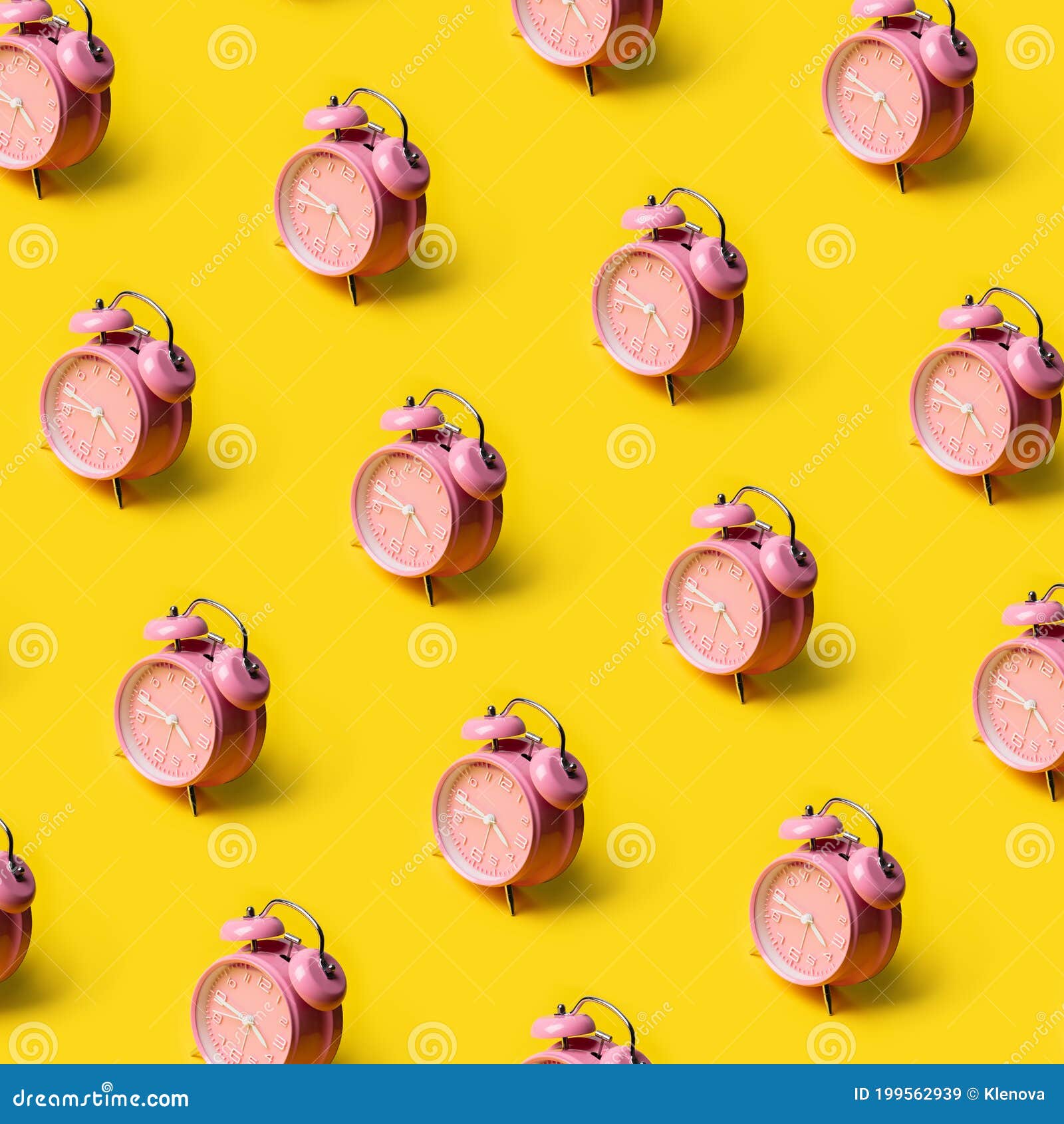 Creative Layout of Pink Alarm Clock`s on Pastel Yellow Background