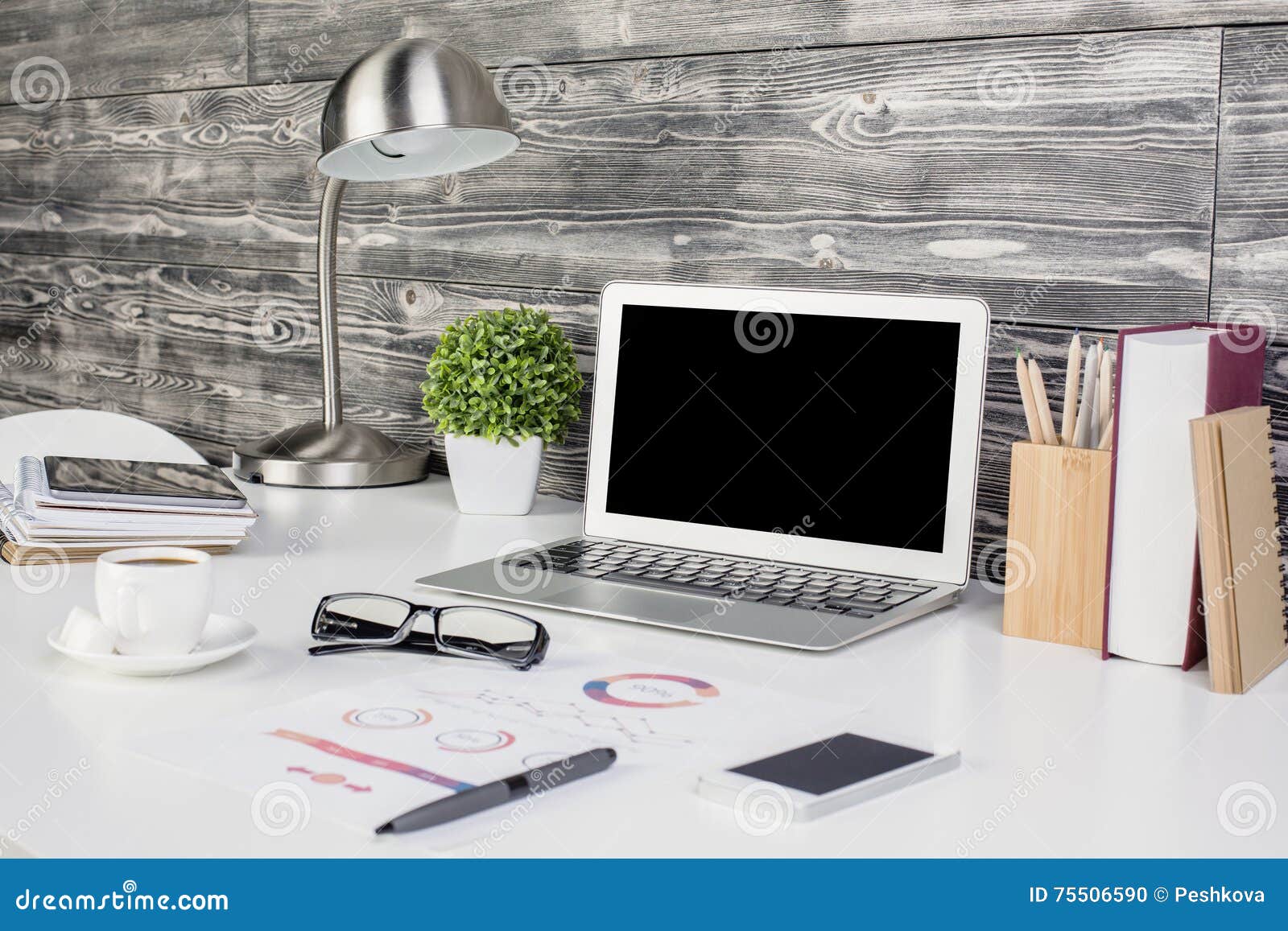 creative office desktop with blank laptop