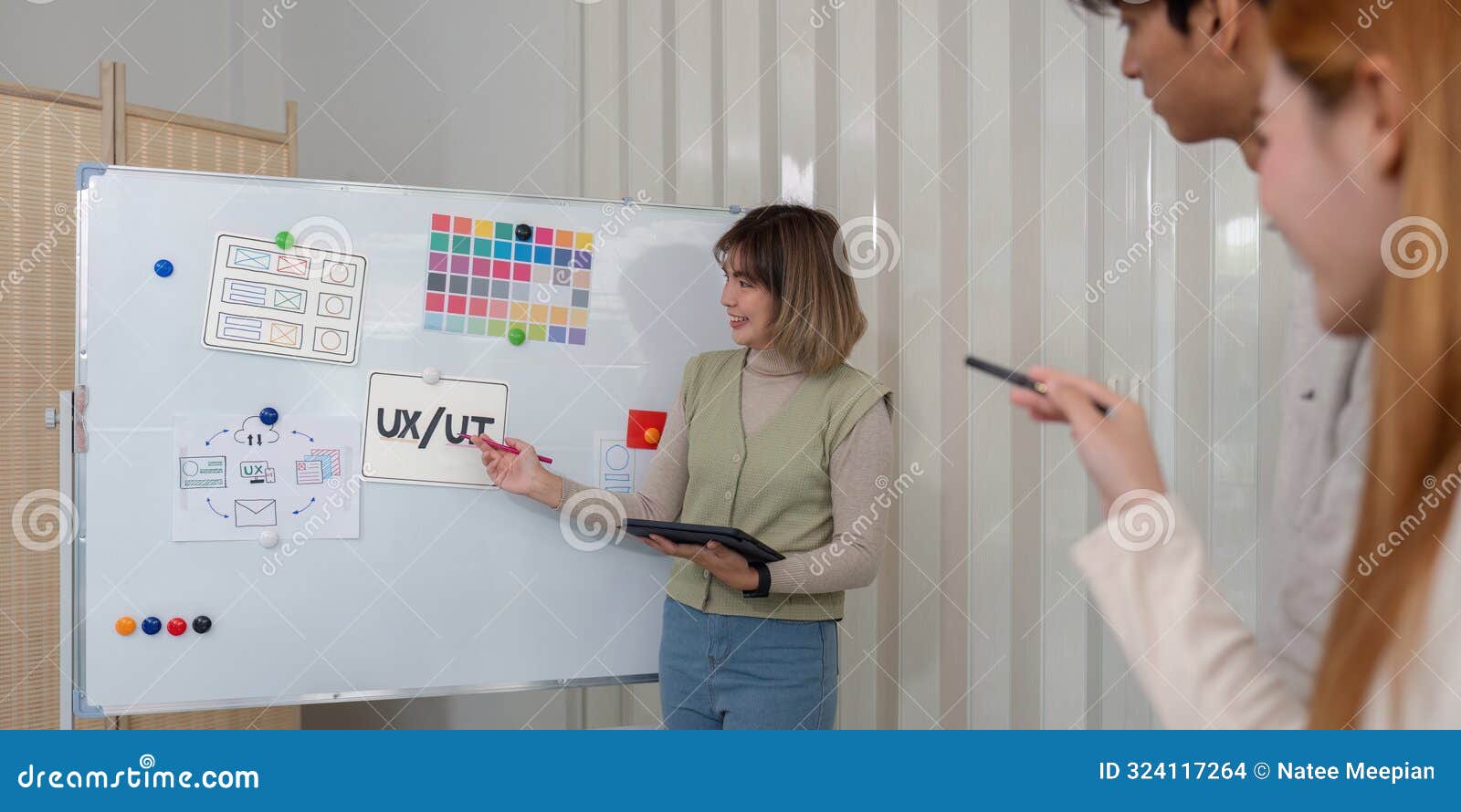 creative ux developer and ui er brainstorming session in modern office with whiteboard and digital tools