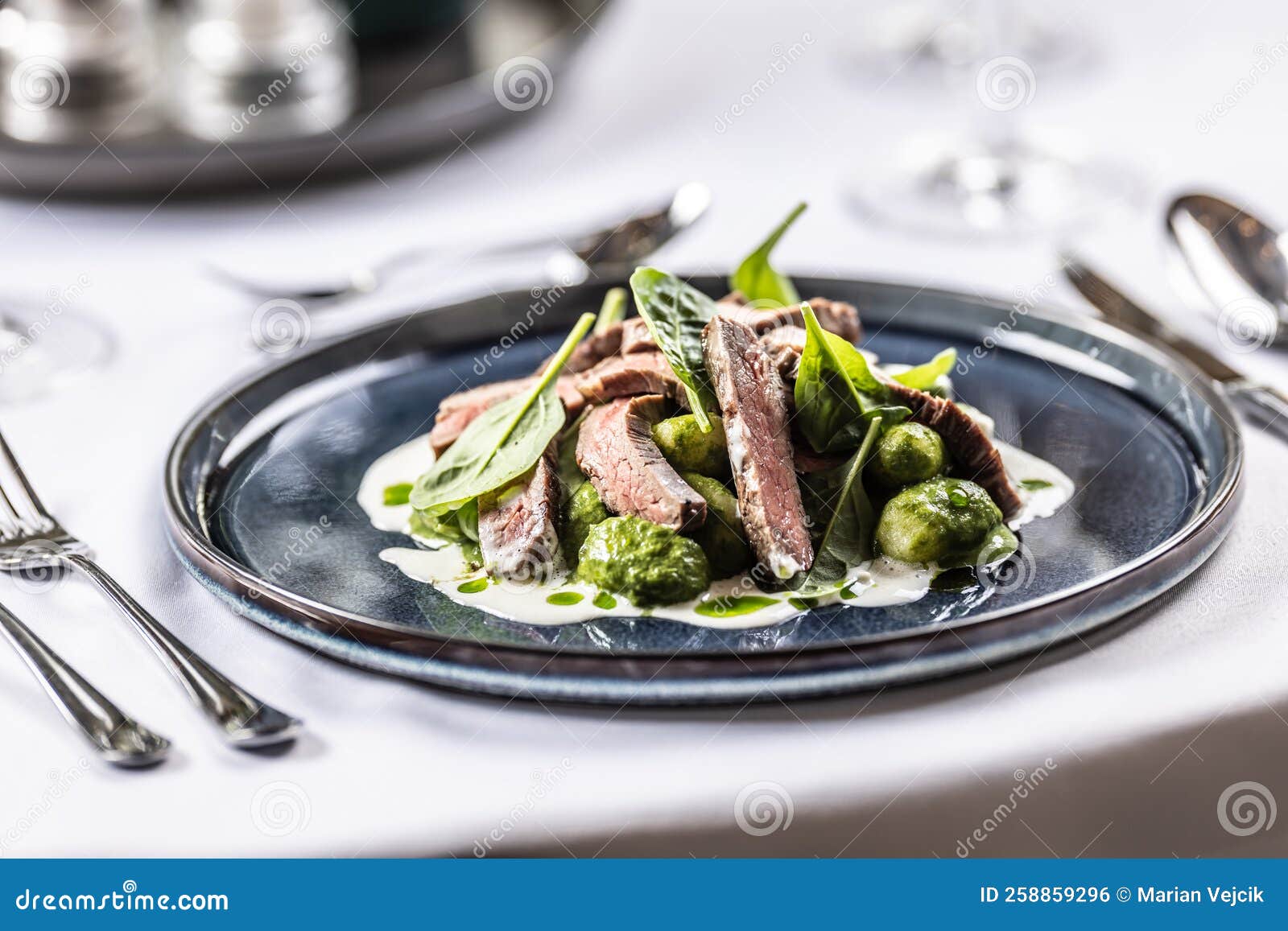 Creatively Cooked Beef Flank Steak with Spinach Gnocchi Served on a