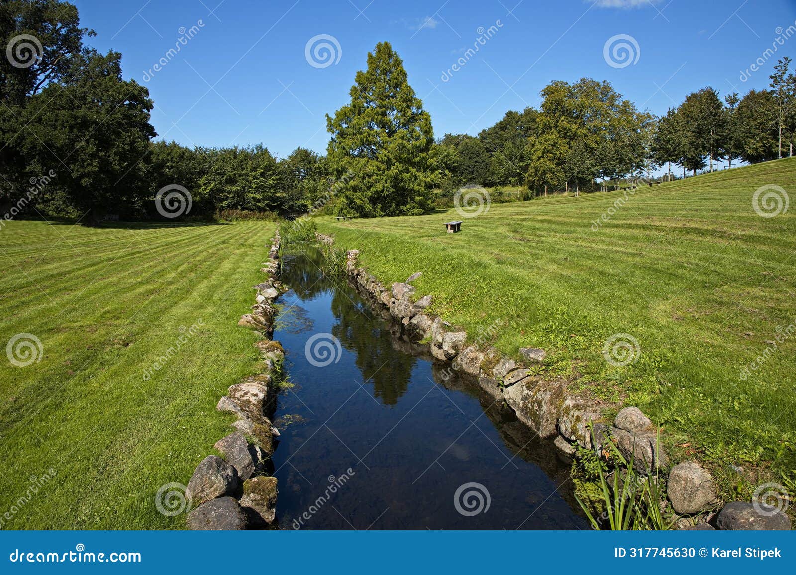 creek in the palace garden of egeskov castle near kvaerndrup, island of funen, denmark