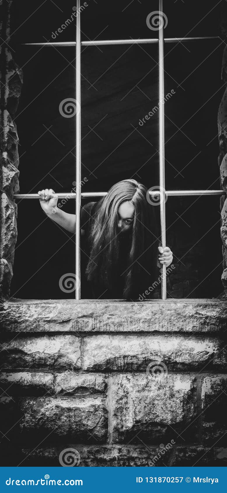 Portrait of a Girl in Scary Costume Climbing Out a Window Stock Image