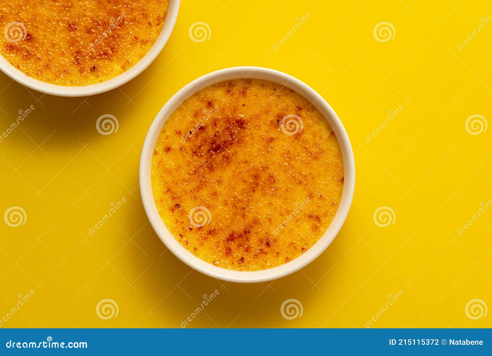 creme brulee in ramekin  on bright yellow color background.
