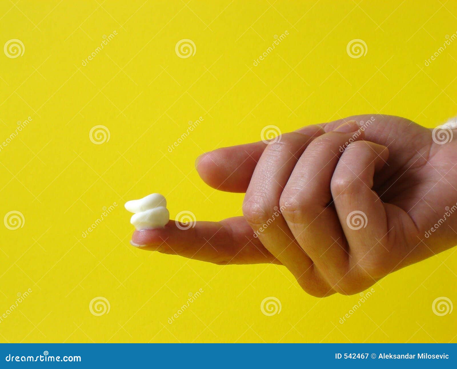 Creme on a finger stock image. Image of white, soft, hand 542467