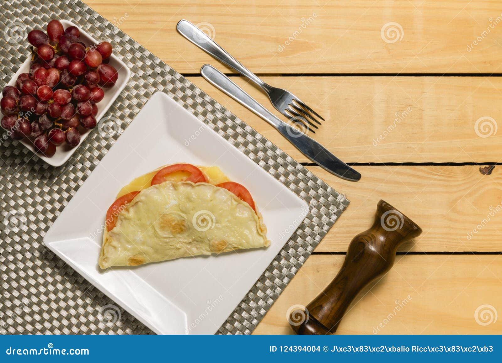 crepioca - pancake of cassava tapioca with tomatoes and cheese on plate on wooden background