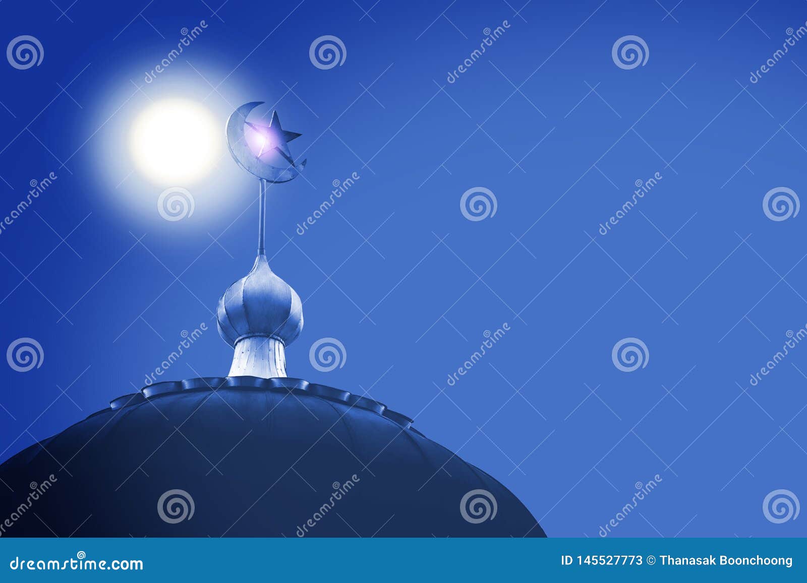 crescent and star,  of islam on dome of the mosque with blue sky