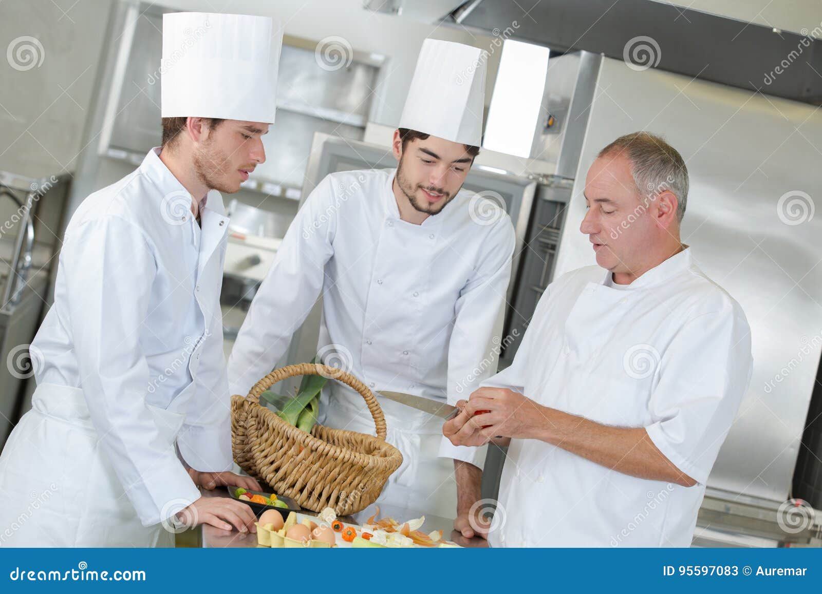 Crew Positive Professional Cooks Working at Restaurant Kitchen Stock
