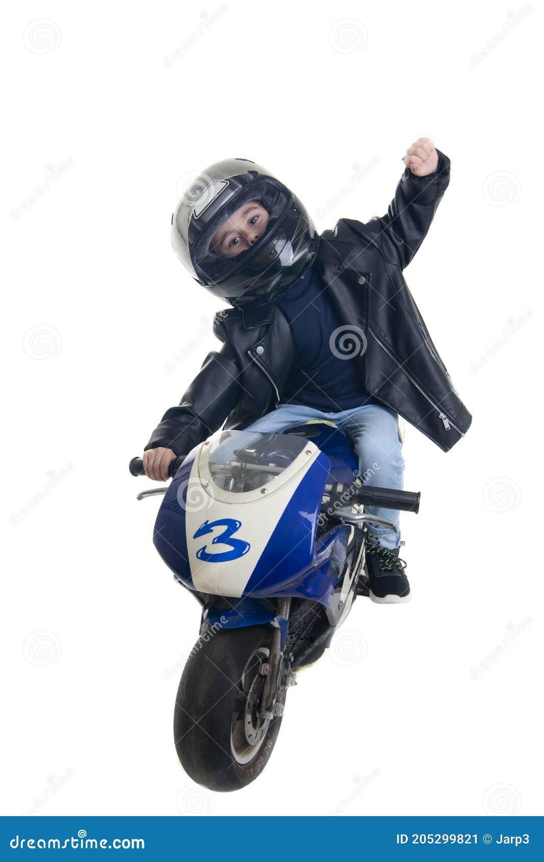 Criança Andando De Moto Com a Mão Levantada Imagem de Stock