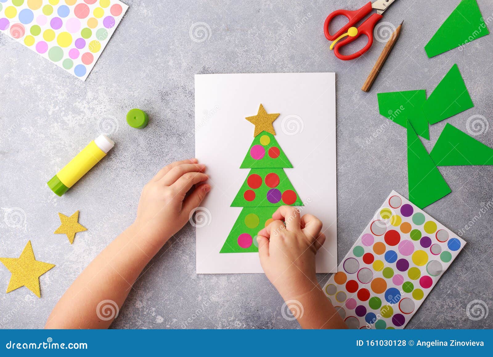 A criança faz um cartão de felicitações colagem de papel de natal, projeto  de arte infantil, para crianças foto de alta qualidade