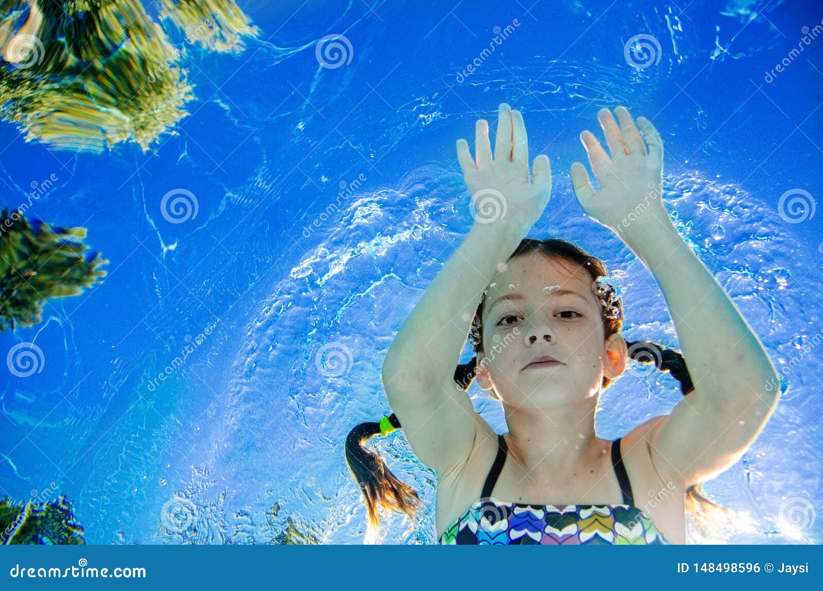 Little Child Swims Underwater In Swimming Pool, Happy 