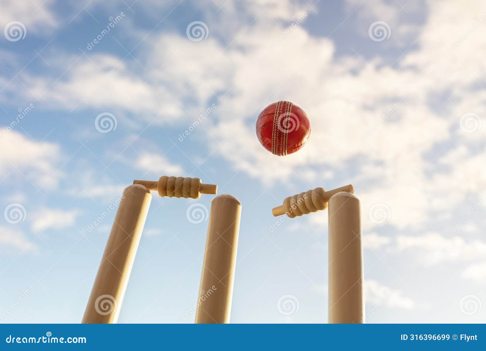 cricket ball hitting wicket stumps and bails background