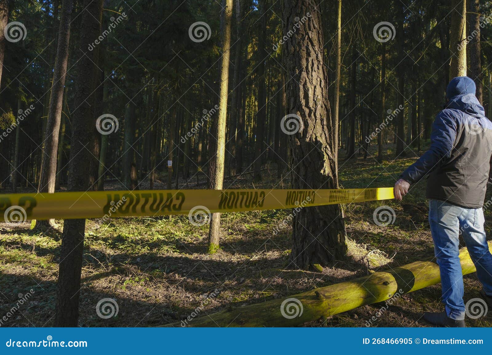 Crime Scene.stop Motion Tape. Man Pulling Yellow Barrier Tape in Dark