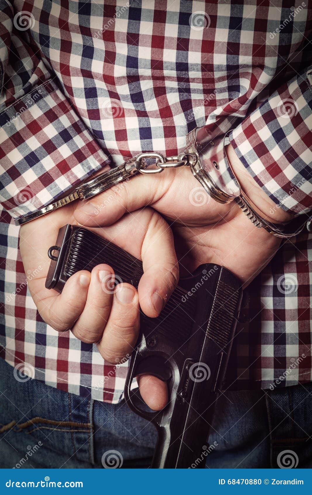 Criminal Hands Locked in Handcuffs on Dark Background Stock Photo
