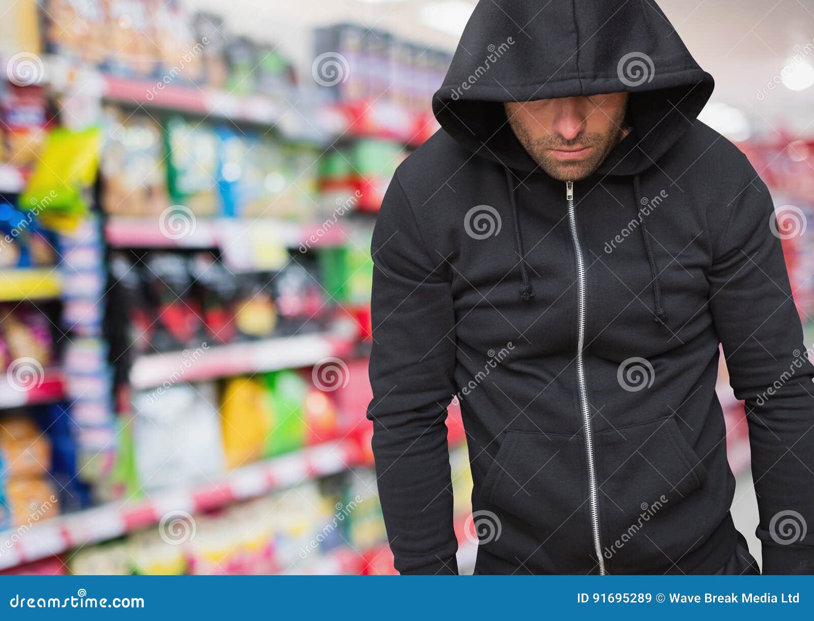 Robbery in store. Robber is aiming and threatening with gun in shop. Stock  Photo