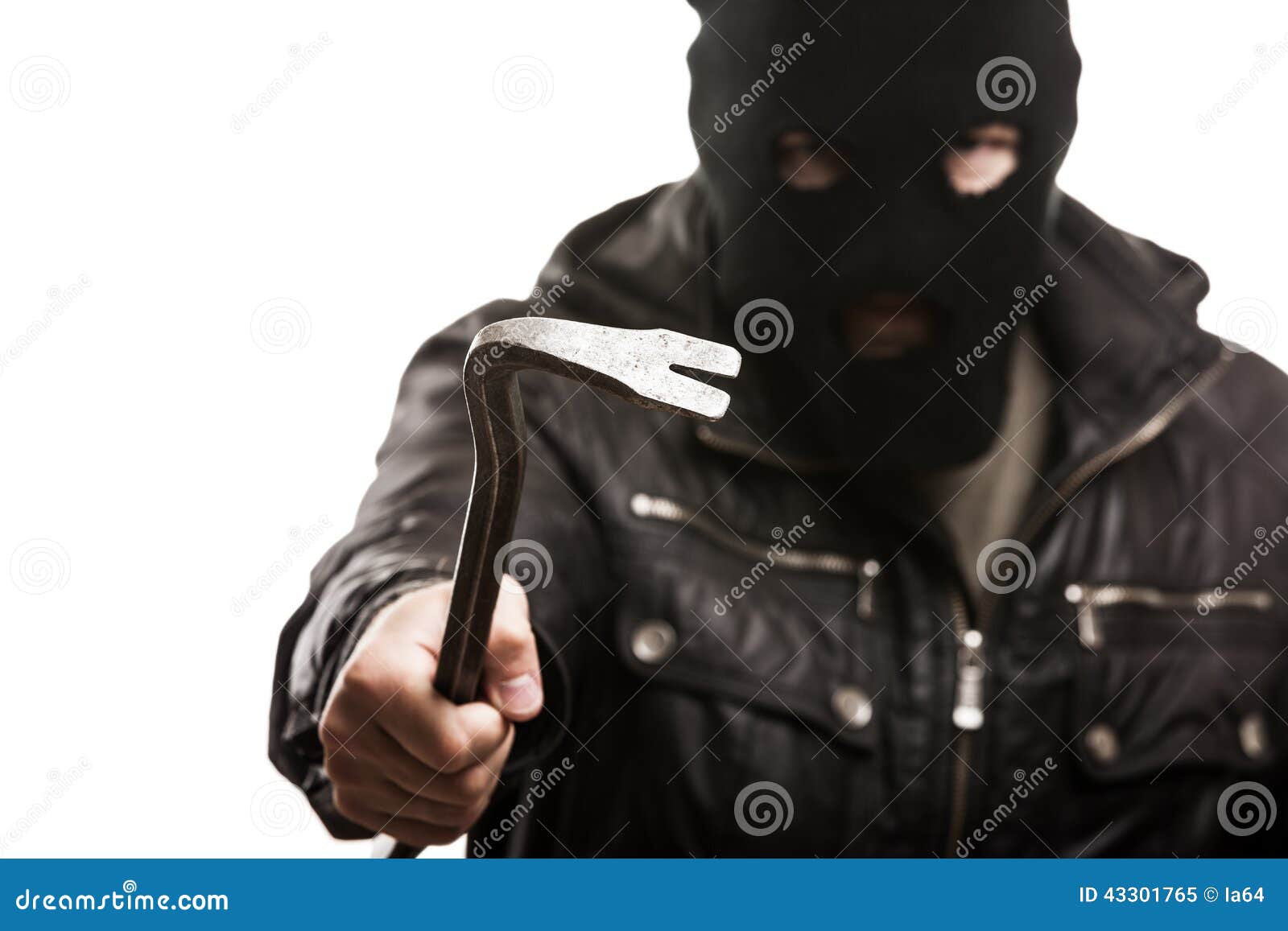 criminal thief or burglar man in balaclava or mask holding crowbar in hand