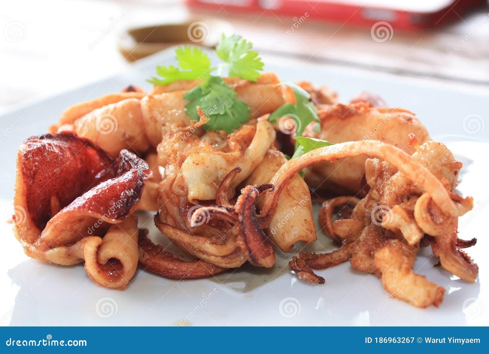 crisp fried calamari or deep fried squid with garlic in the white plate