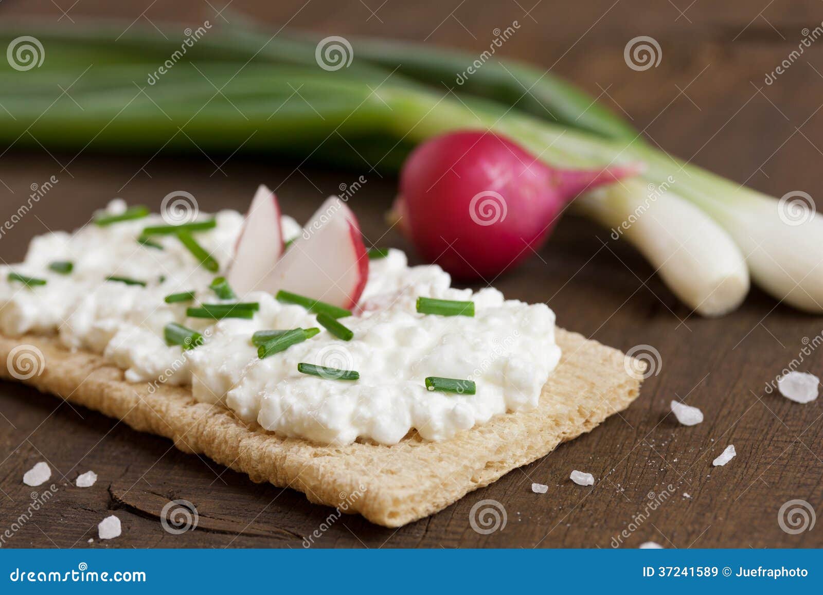 Crispbread with cream cheese on a wooden board