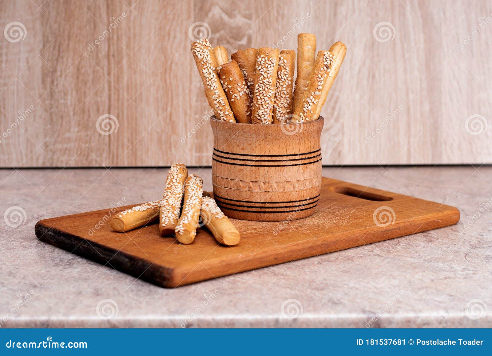 Crispy Bread Sticks with Sesame Seeds and Bran Bread on a Wooden Board
