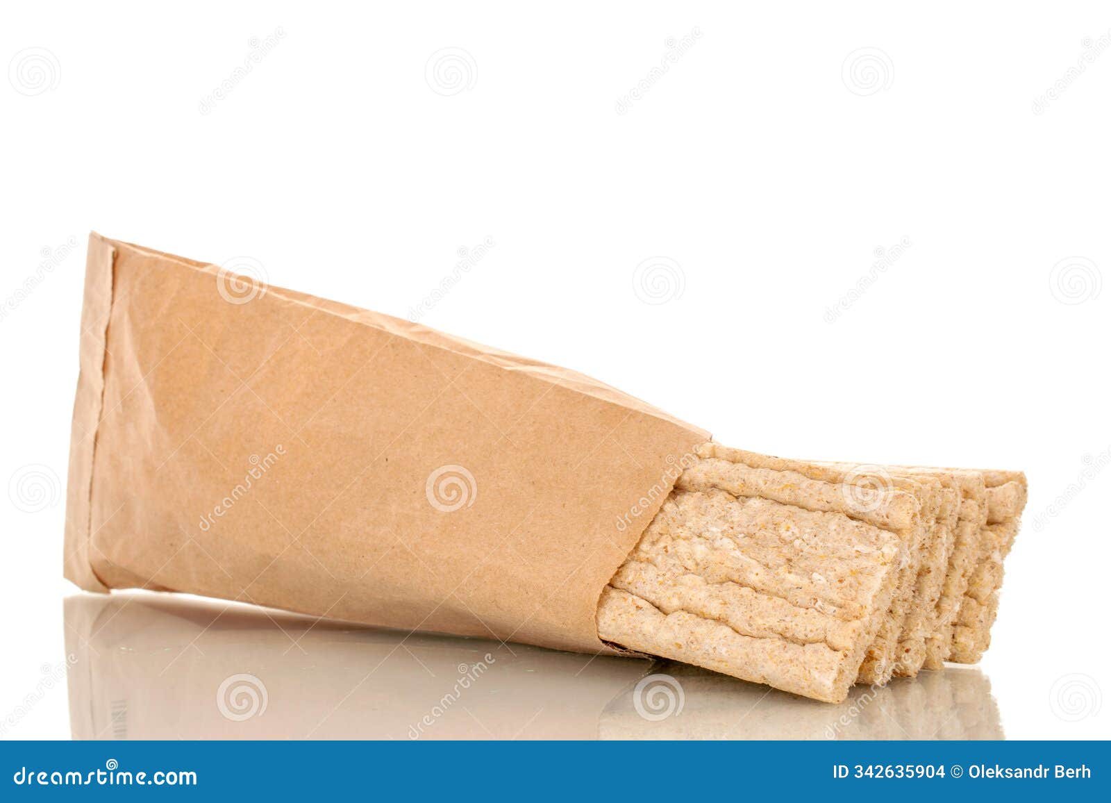 light brown multi-grain rye crispbread on a wooden table. crispy tasty crackers with ceramic dishes, macro,  on white back