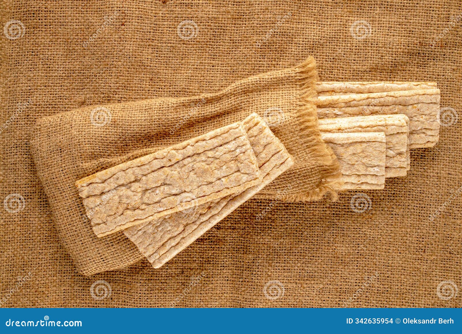 light brown multi-grain rye crispbread on a wooden table. crispy tasty crackers with ceramic dishes, macro,  on white back