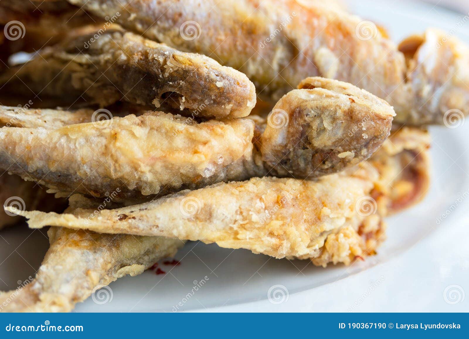 crispy fried fish on a white background. tasty mullus in a restaurant in odessa. traveling in ukraine