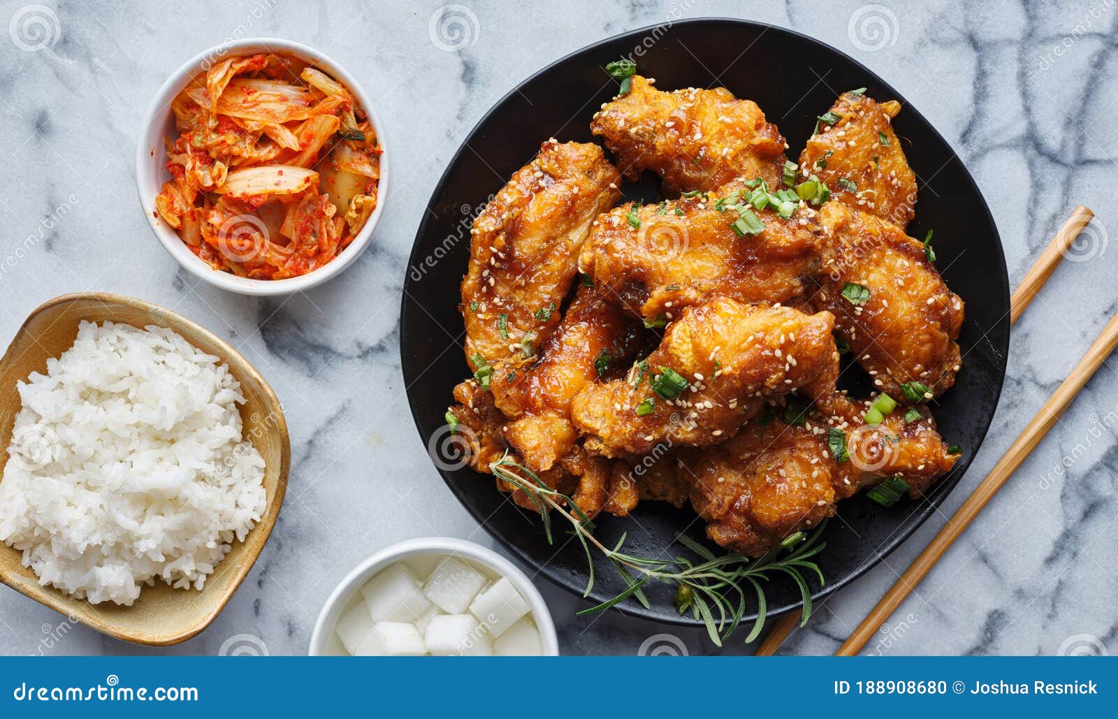 crispy fried korean chicken wings in galbi sauce with pickled radish, kimchi, and rice side dishes