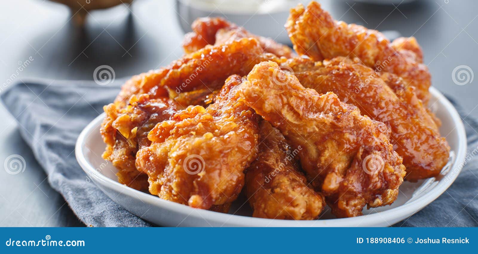 crispy fried korean chicken wings in soy garlic sauce with pickled radish and kimchi sides