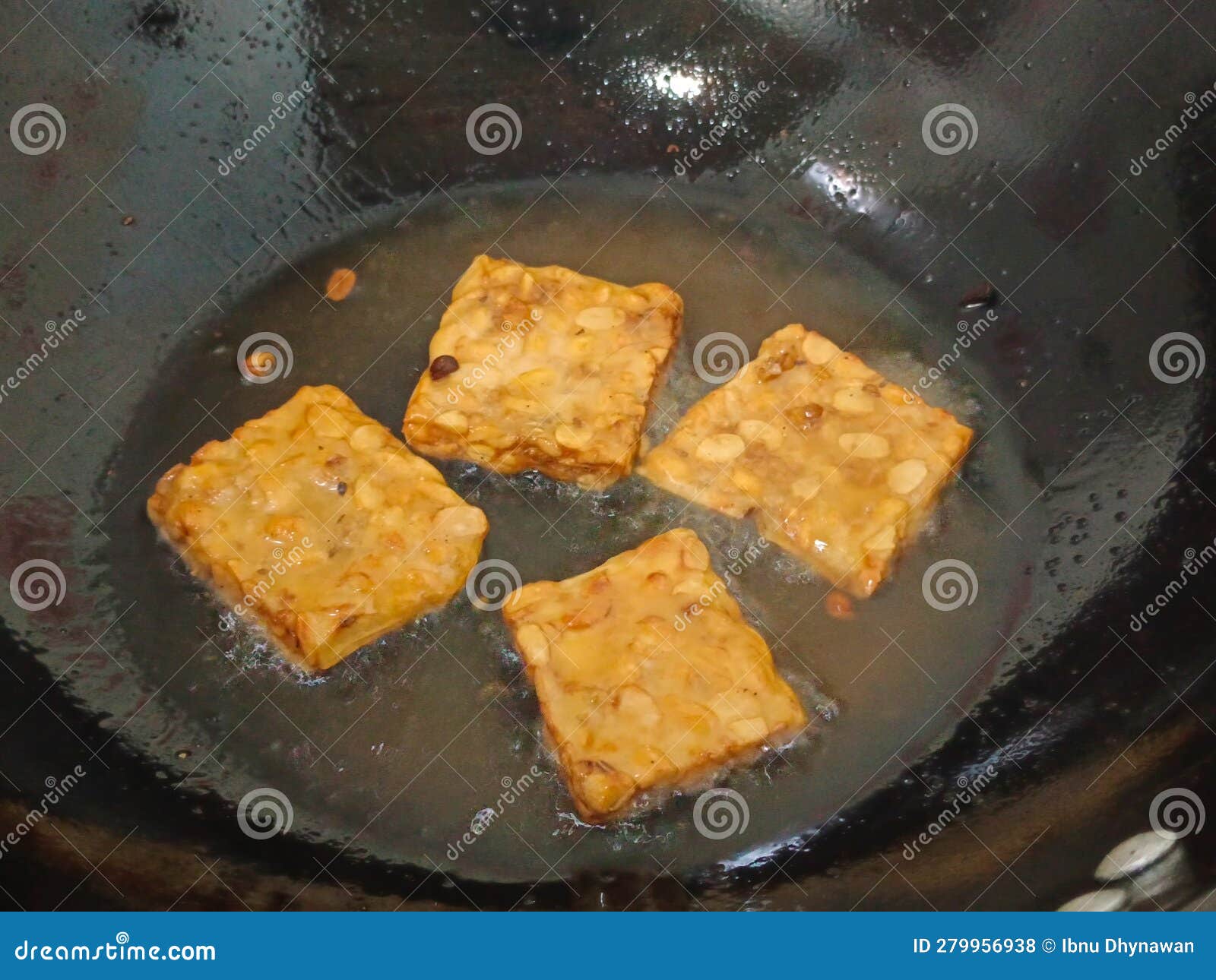 Crispy Fried Tempeh with a Savory Background on a Frying Pan Stock