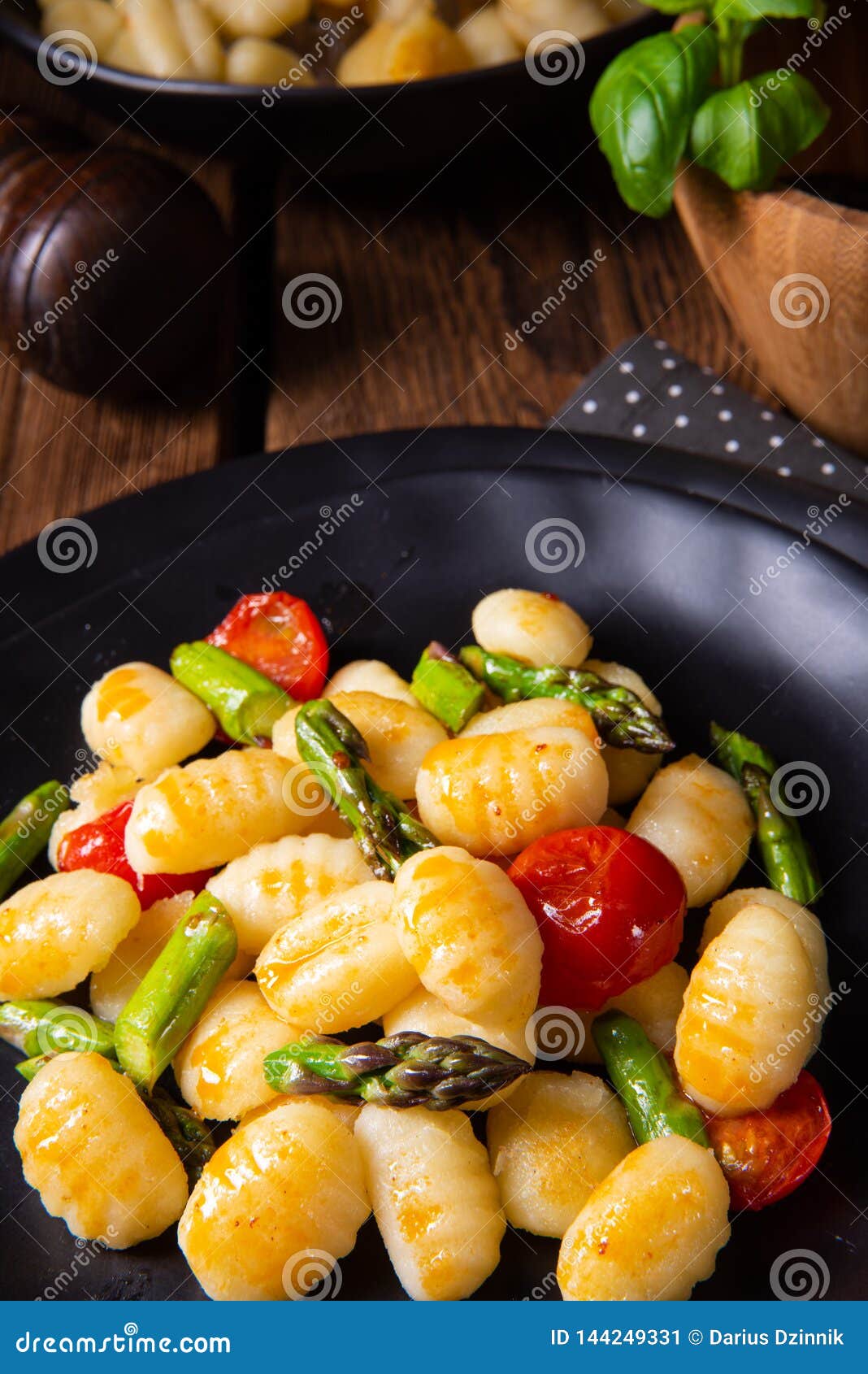 A Crispy Gnocchi with Roasted Asparagus and Tomatoes Stock Image