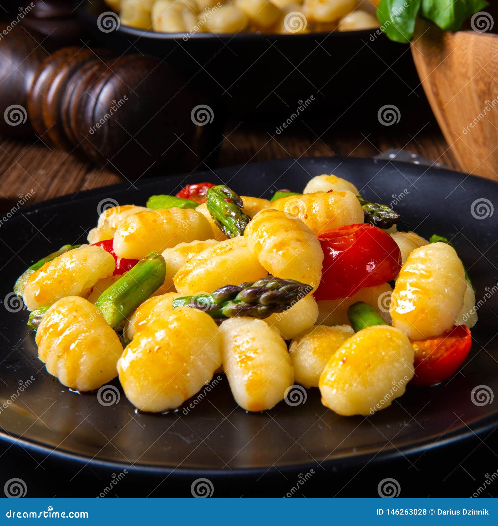 A Crispy Gnocchi with Roasted Asparagus and Tomatoes Stock Photo