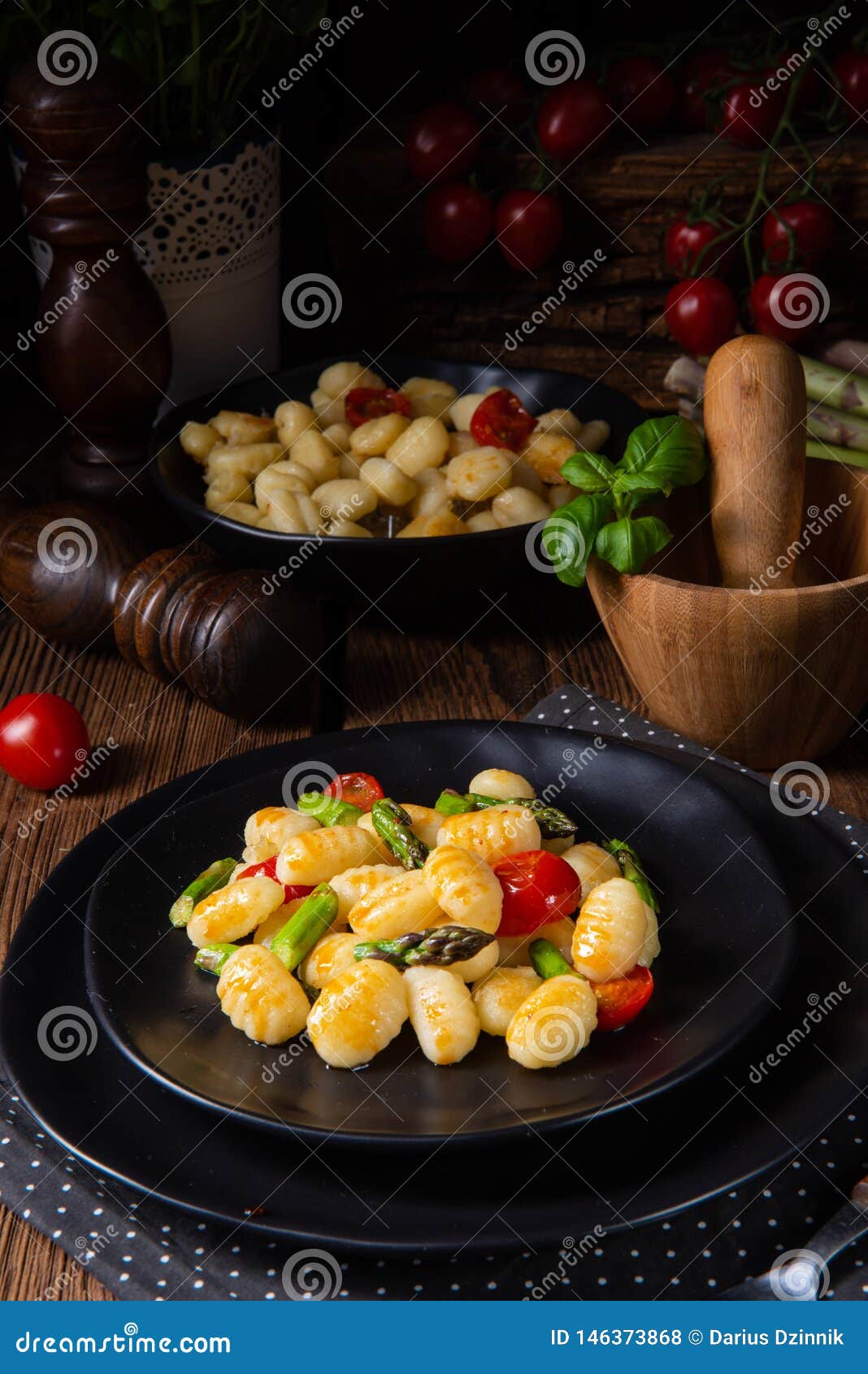 A Crispy Gnocchi with Roasted Asparagus and Tomatoes Stock Photo