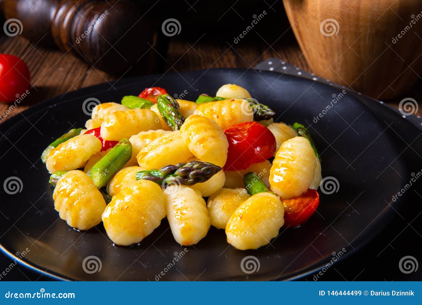 A Crispy Gnocchi with Roasted Asparagus and Tomatoes Stock Image