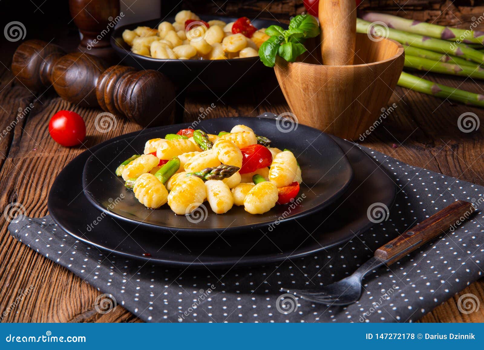 A Crispy Gnocchi with Roasted Asparagus and Tomatoes Stock Photo
