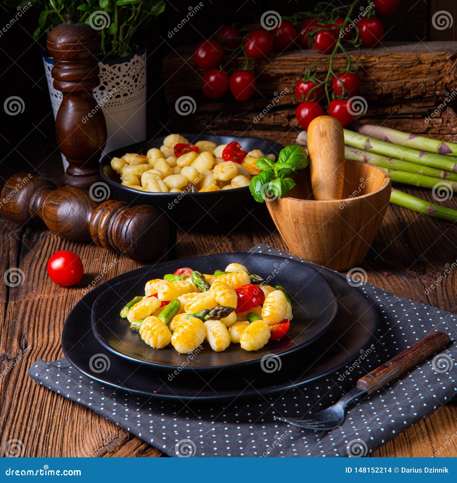 A Crispy Gnocchi with Roasted Asparagus and Tomatoes Stock Photo