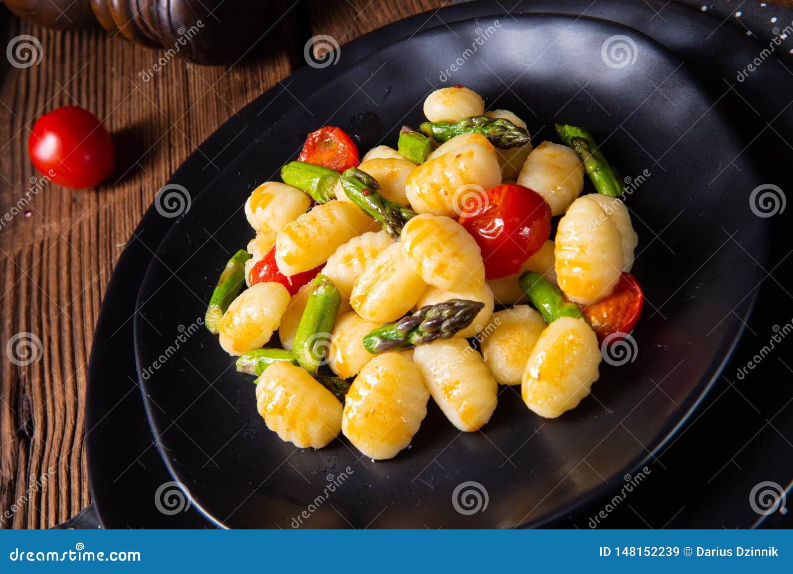 A Crispy Gnocchi with Roasted Asparagus and Tomatoes Stock Image