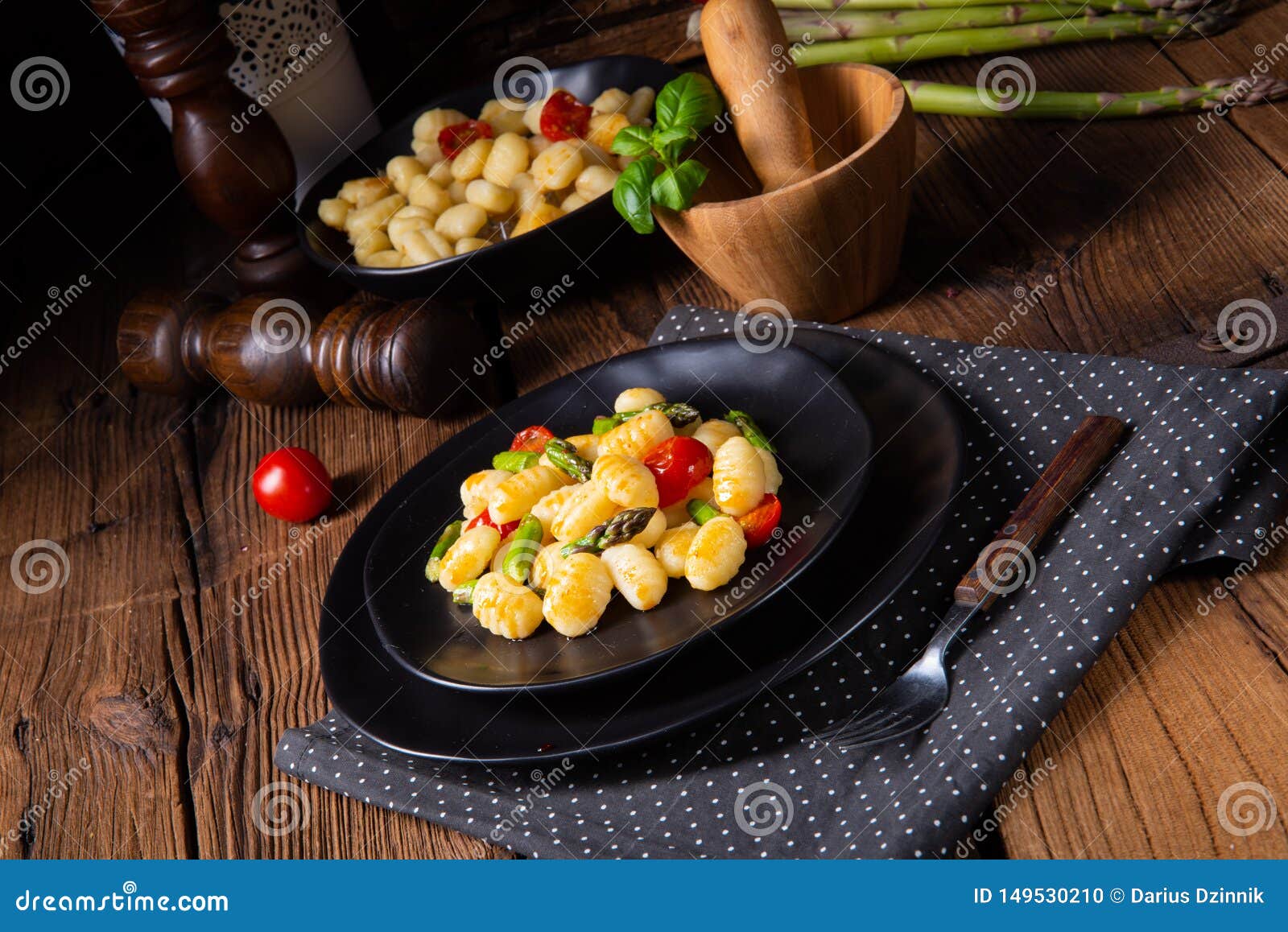 A Crispy Gnocchi with Roasted Asparagus and Tomatoes Stock Photo