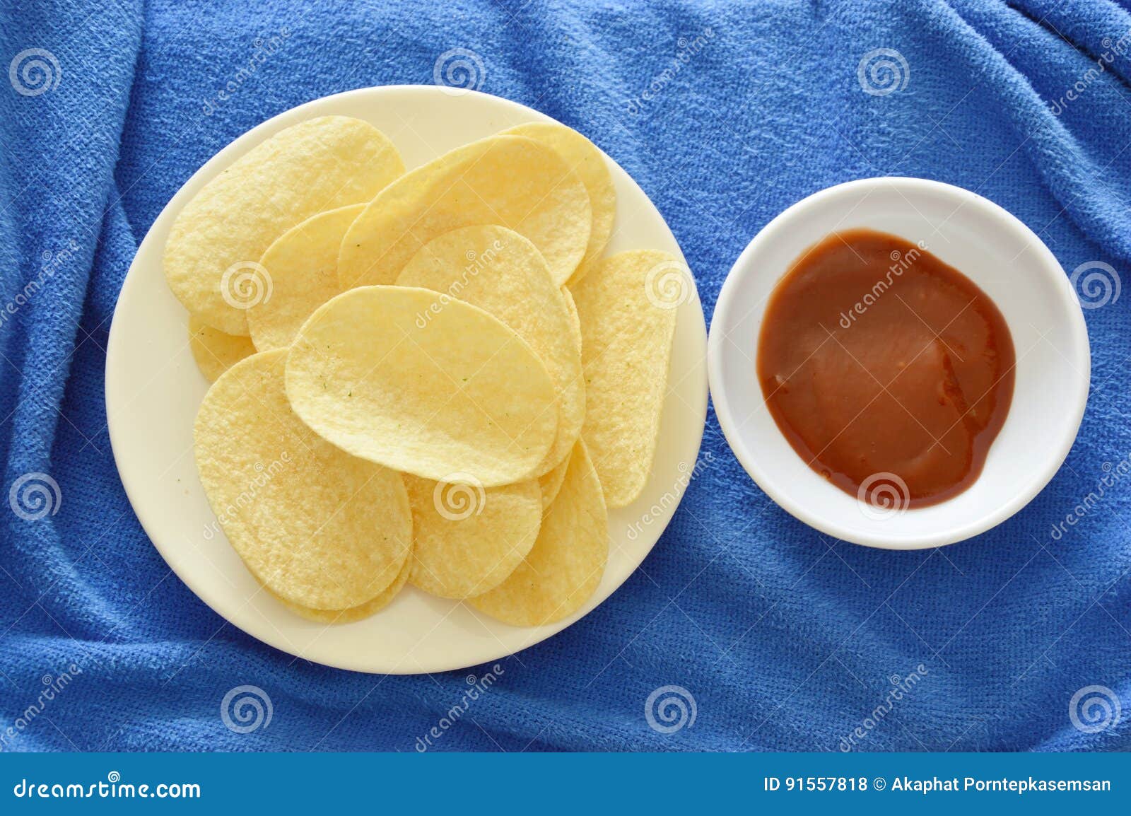 Crispy and Salt Potato Chips on Dish Dipping with Ketchup Stock Photo