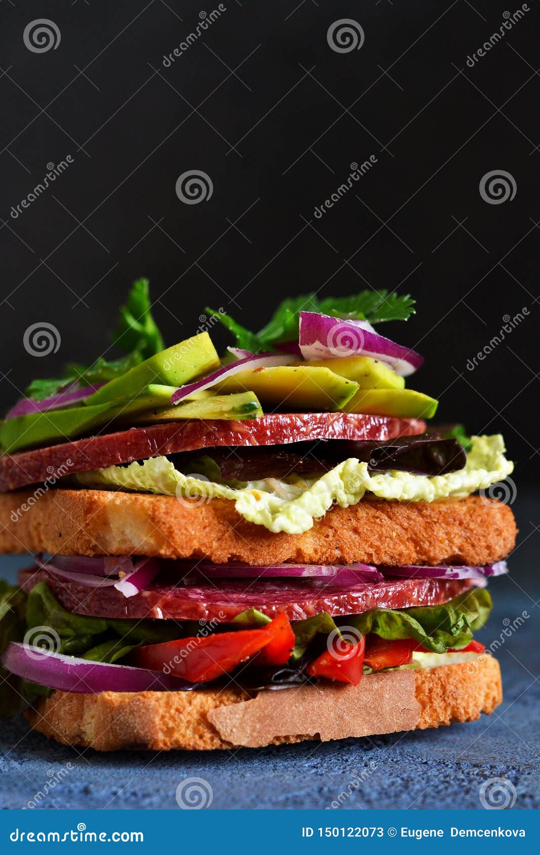 Crispy Sandwich with Salami, Salad and Vegetables on the Kitchen Table