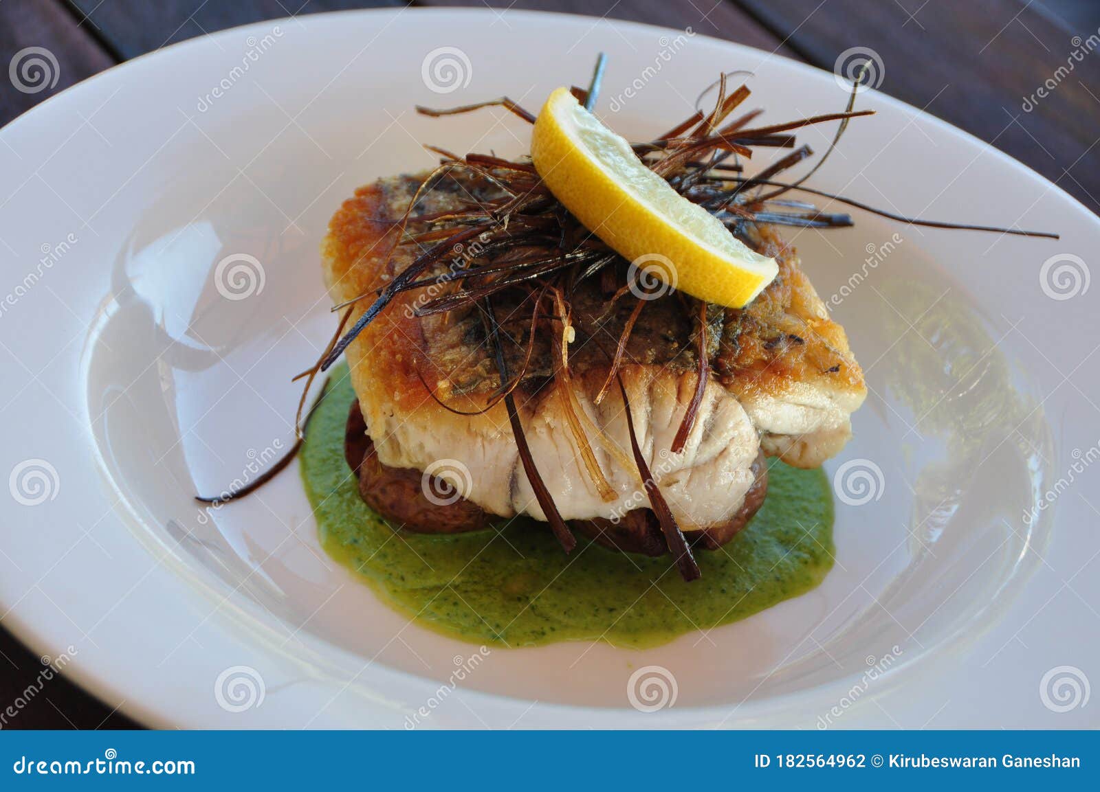 Crispy Skinned Barramundi on a White Plate Stock Photo Image of sauce